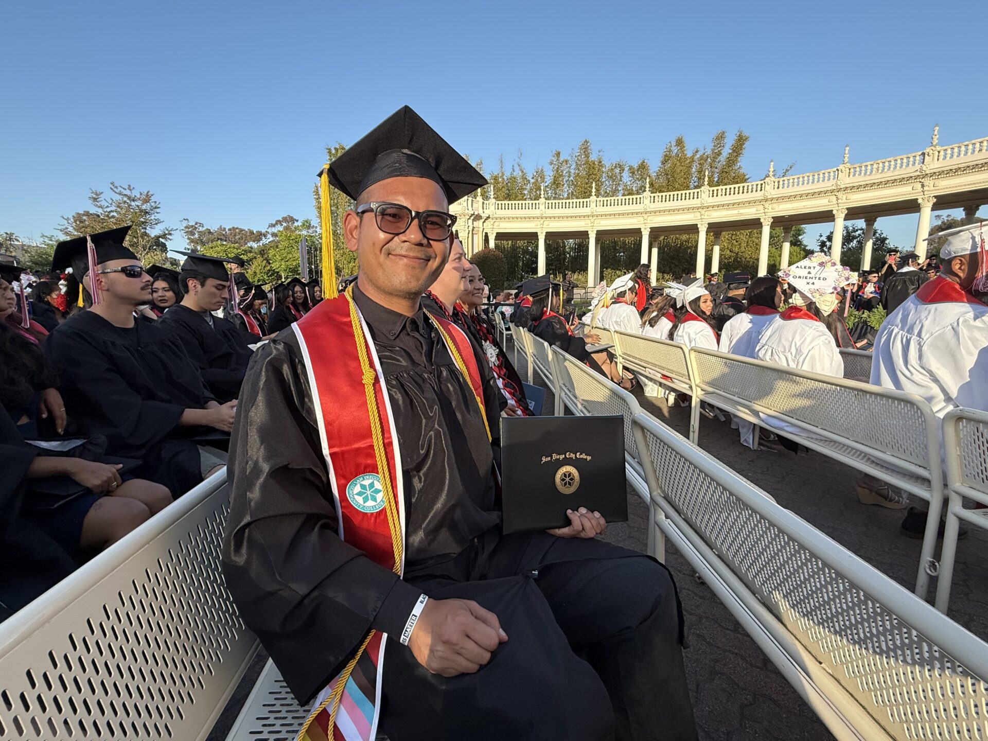 Me after having walked for graduation at commencement with my diploma (placeholder) in hand